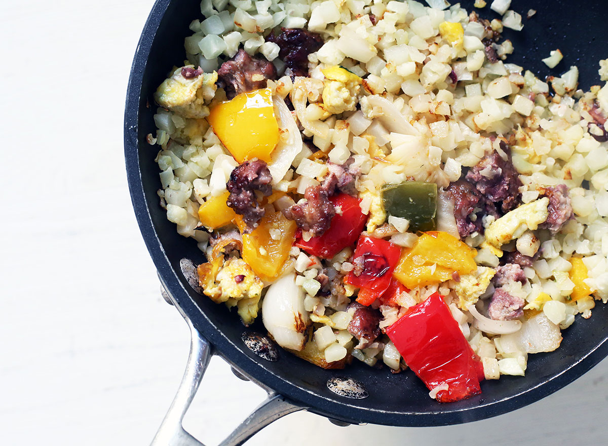 Whole30 breakfast cauliflower rice with veggies, eggs, and bacon