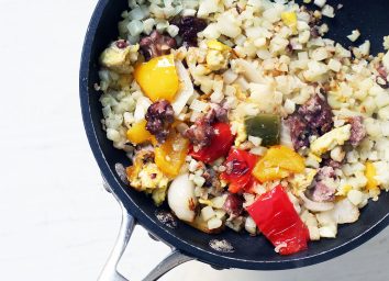 Whole30 breakfast cauliflower rice with veggies, eggs, and bacon