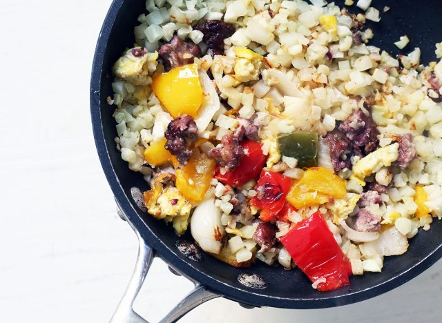 Whole30 breakfast cauliflower rice with veggies, eggs, and bacon