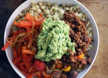 whole 30 burrito bowl with guacamole on top