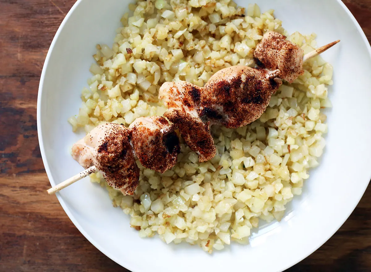 whole30 chicken kababs over celeriac rice on a plate