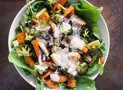 whole 30 roasted vegetable salad with tahini dressing in white bowl