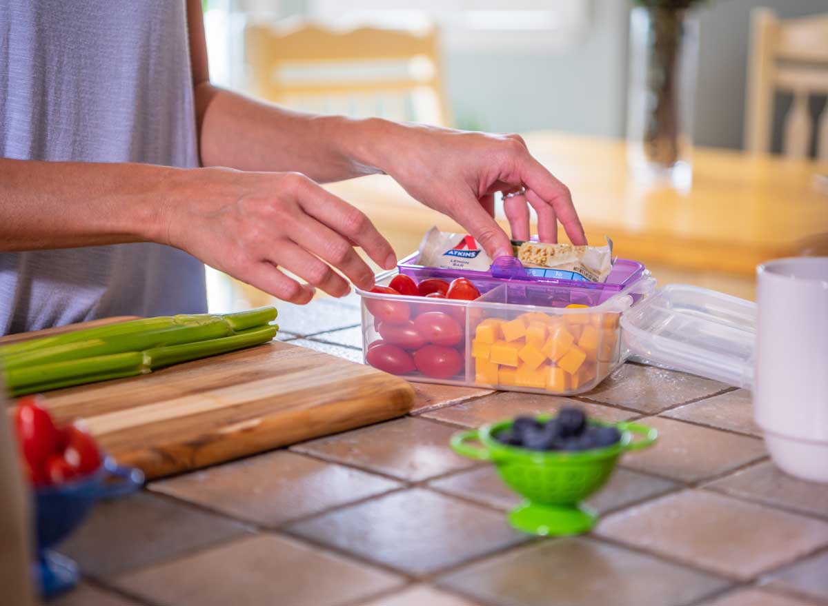 Packing a meal prep lunch with atkins snack