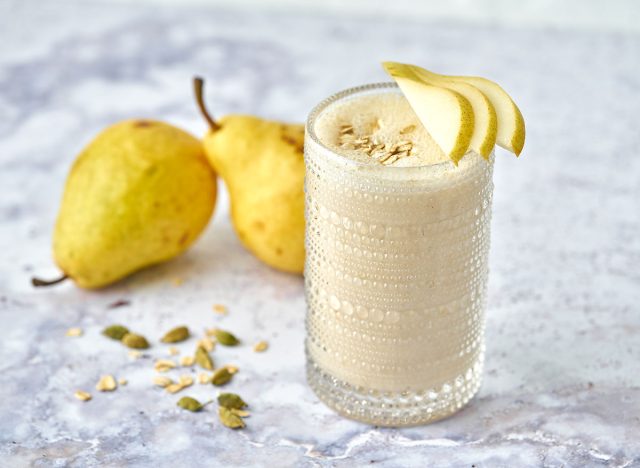 cardamom pear smoothie in glass garnished with pear