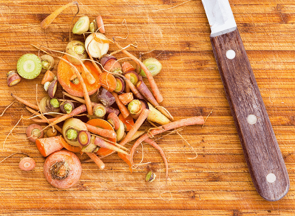 carrot scraps on cutting board with knife