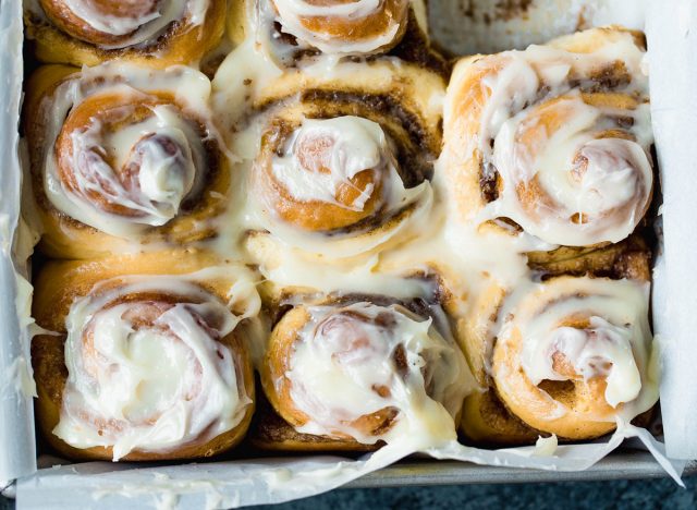 cinnamon rolls with frosting in baking pan