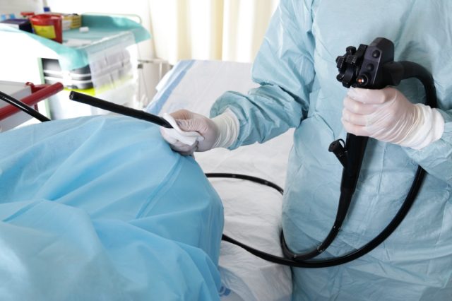 Endoscopy. Doctor holding endoscope before colonoscopy