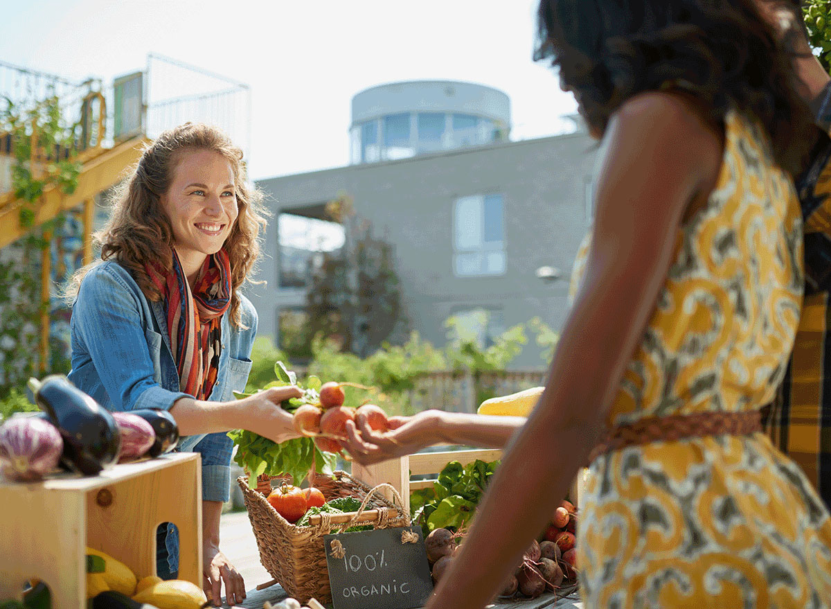 farmers market woman picking out items