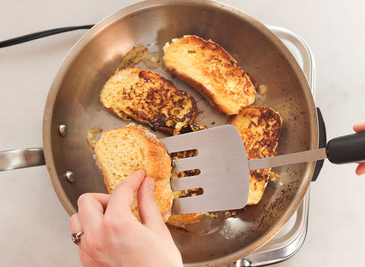 flipping french toast in a pan