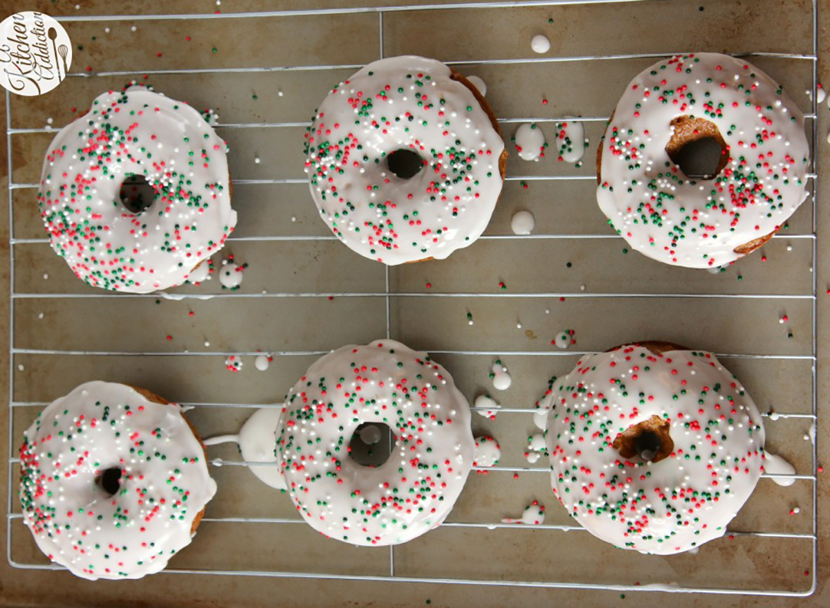 gingerbread donuts with icing and sprinkles on cooling rack