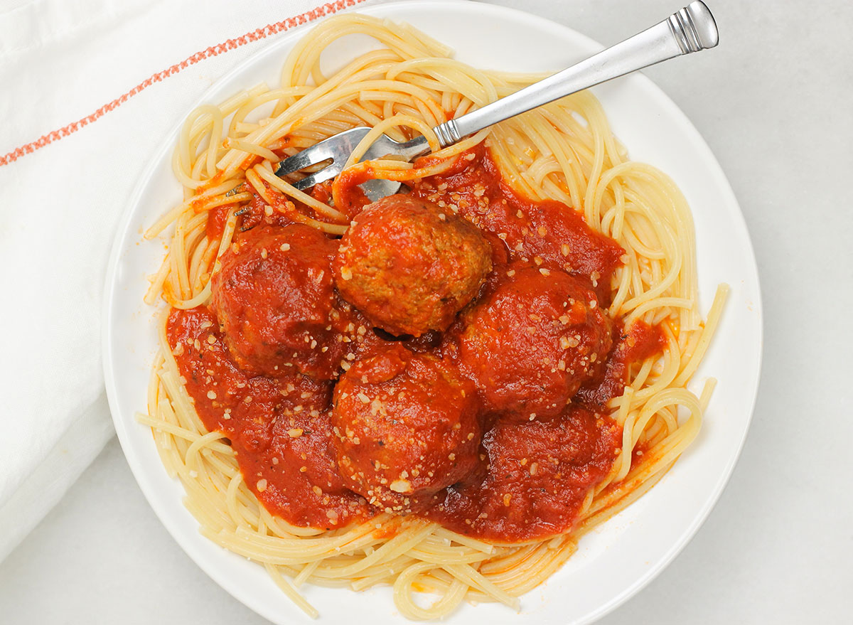 digging into a plate of Italian meatballs