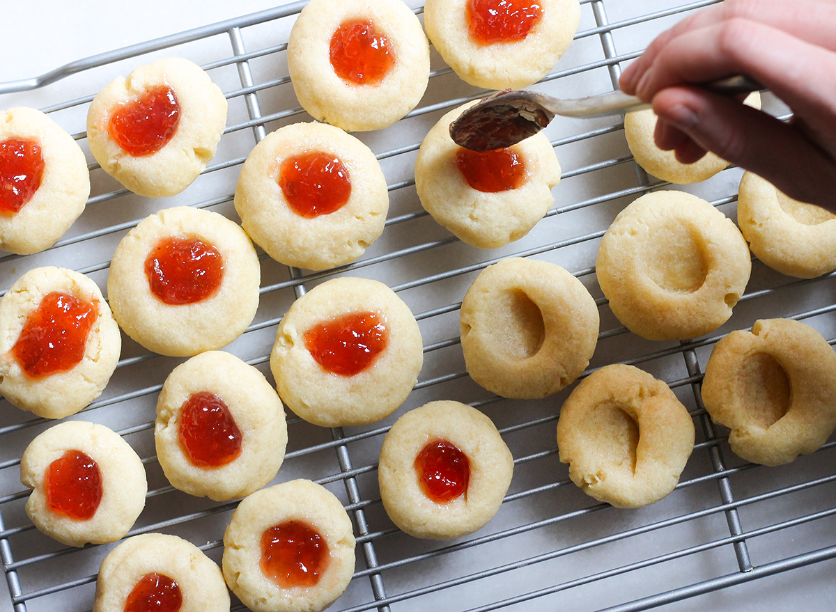 filling jelly into thumbprint cookie