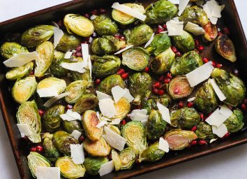 lemon pomegranate brussels sprouts on a sheet pan