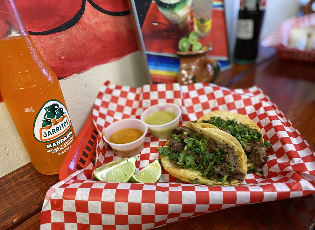 tacos and lime wedges with jarritos soda bottle