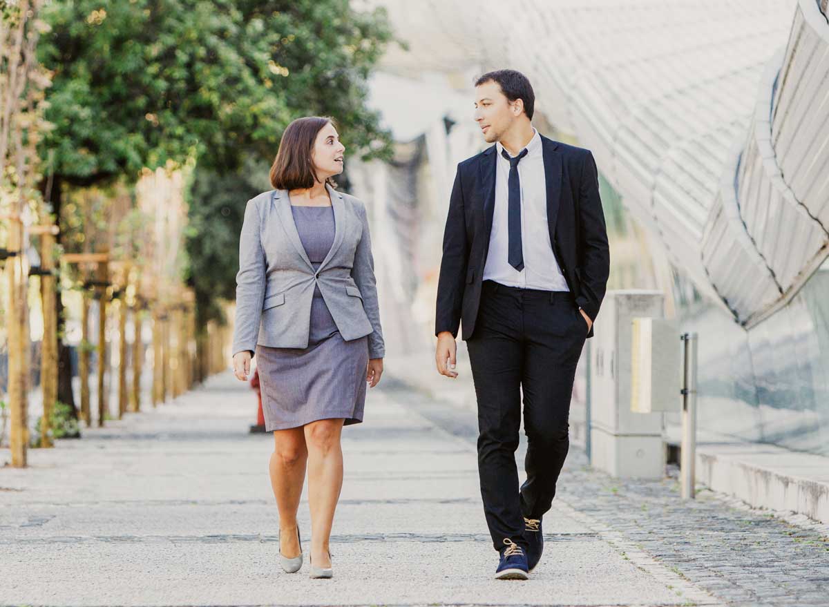 Man and woman colleagues walking around during work