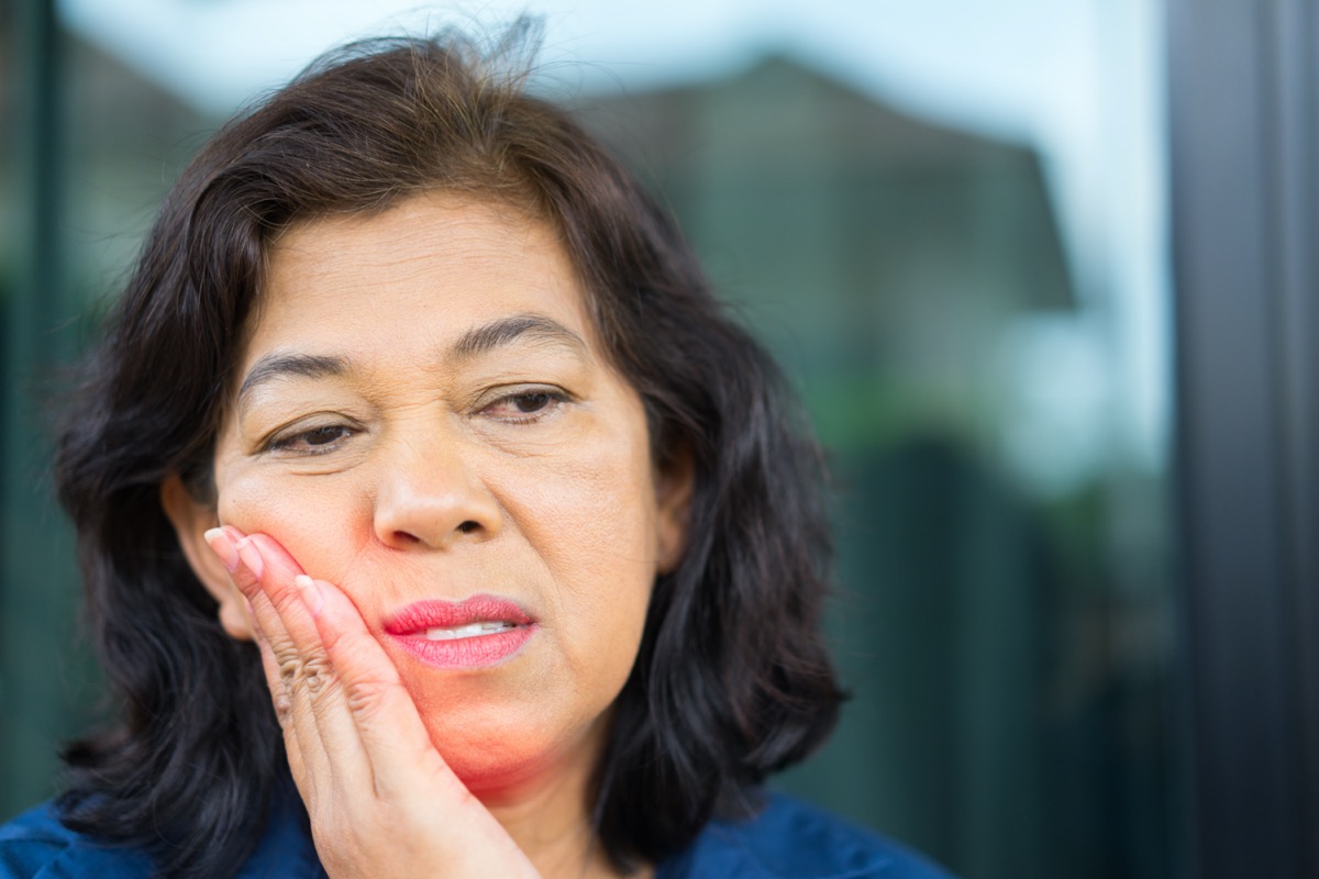 Asian Senior woman feeling tooth pain