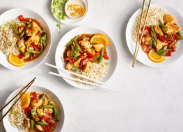 bowls of homemade orange chicken with chopsticks