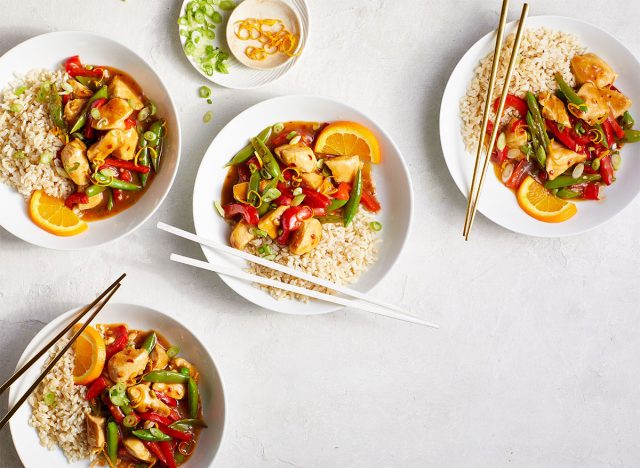 bowls of homemade orange chicken with chopsticks