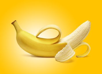peeled banana against a yellow background