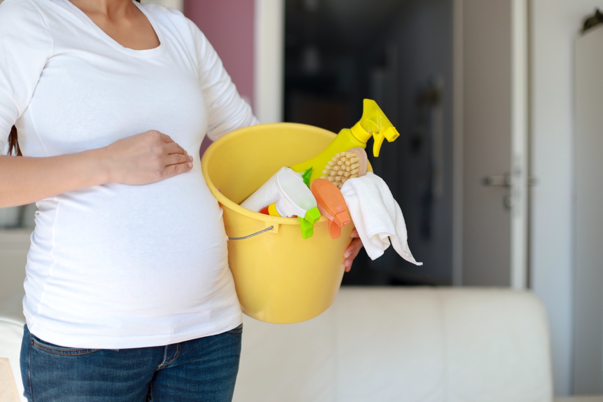 Pregnant woman cleaning items