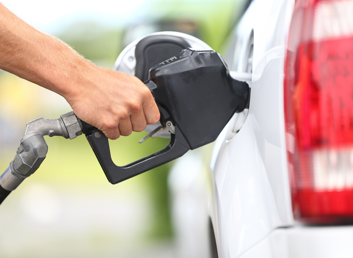 man pumping gas into car