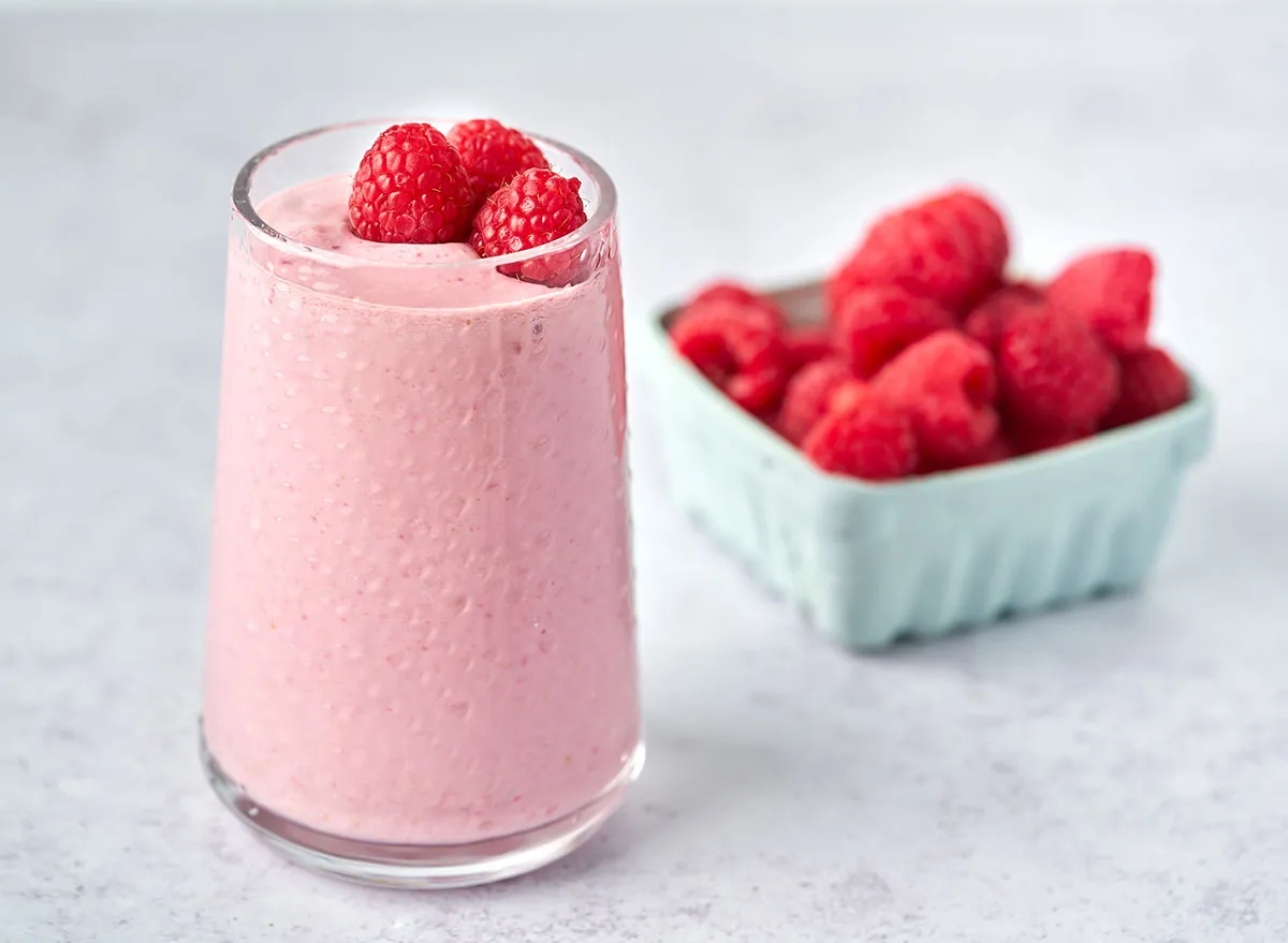 raspberry cashew butter cottage cheese smoothie garnished with raspberries