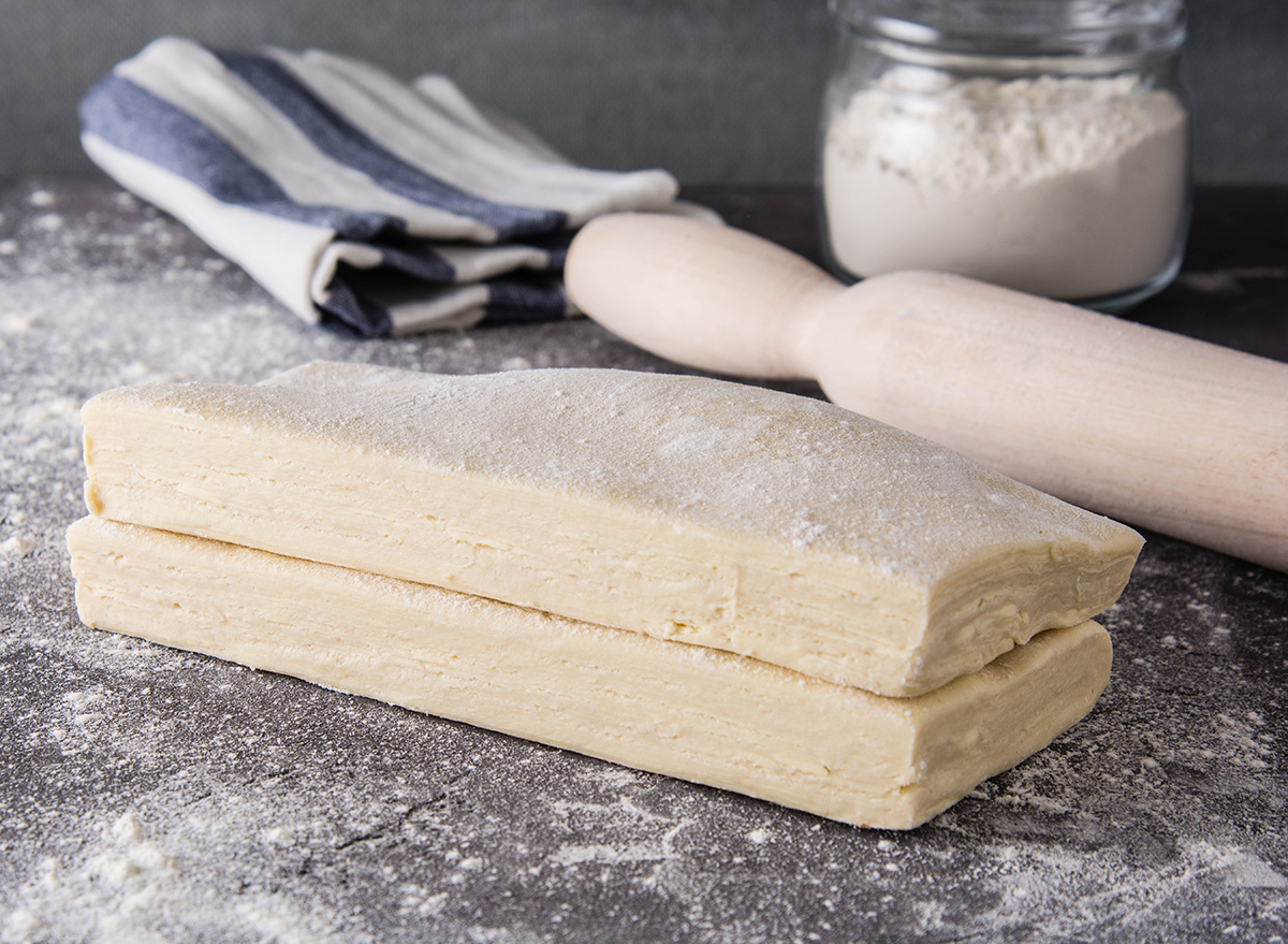 raw puff pastry with rolling pin