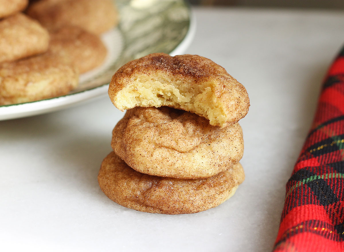 snickerdoodle cookies in a pile with a bite in one cookie