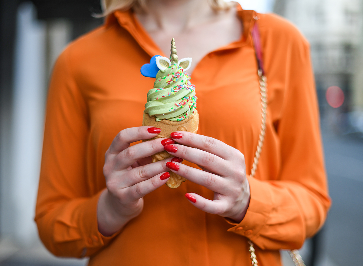 woman holding taiyaki ice cream cone