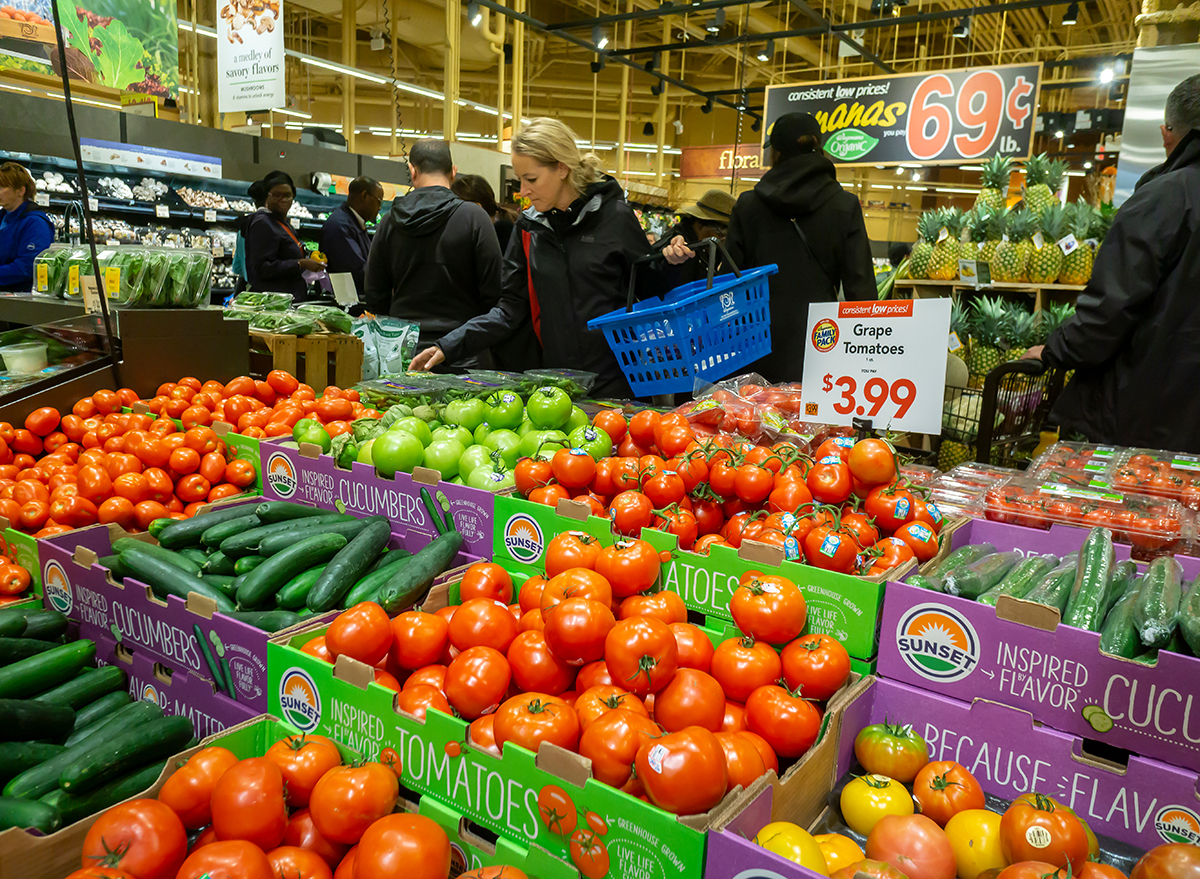 shoppers looking at vegetables in wegmans