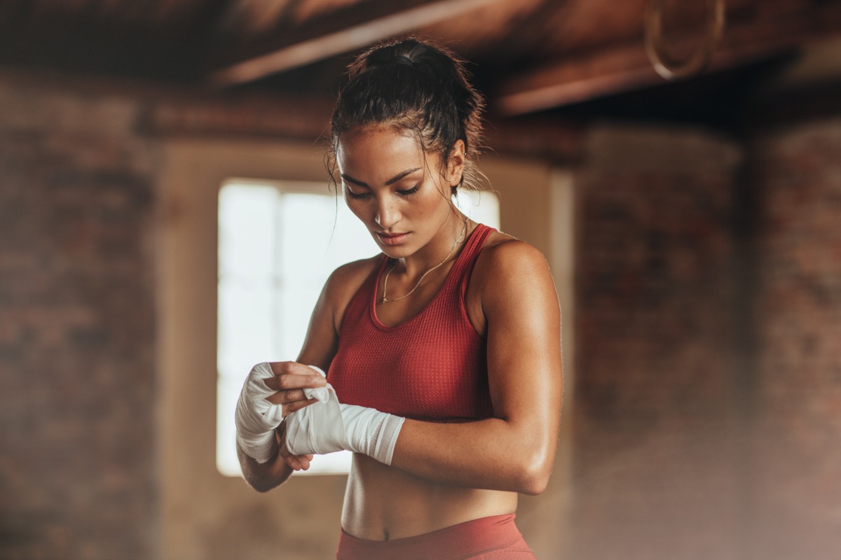 Female boxer wearing strap on wrist