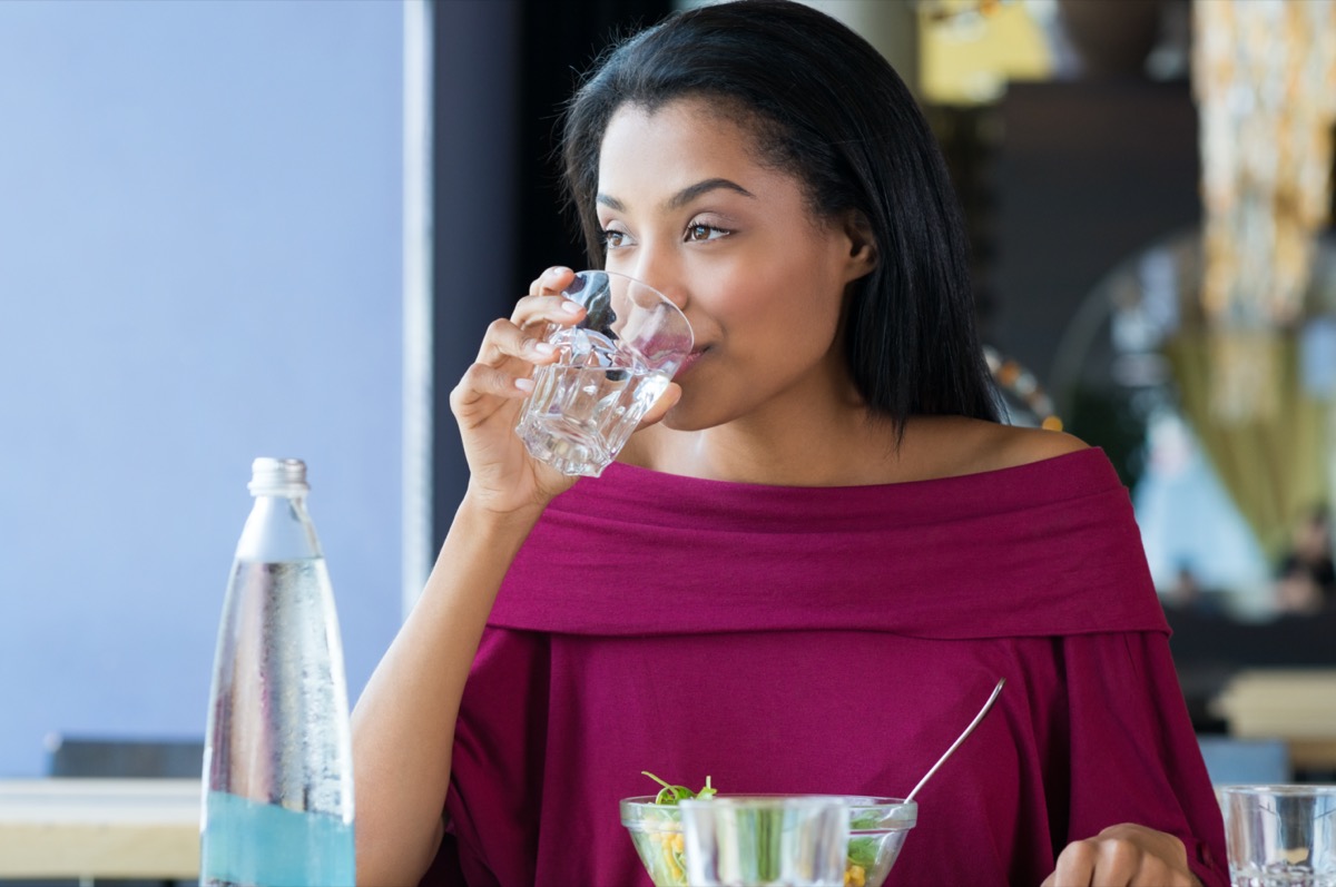 woman drinking a glass of water