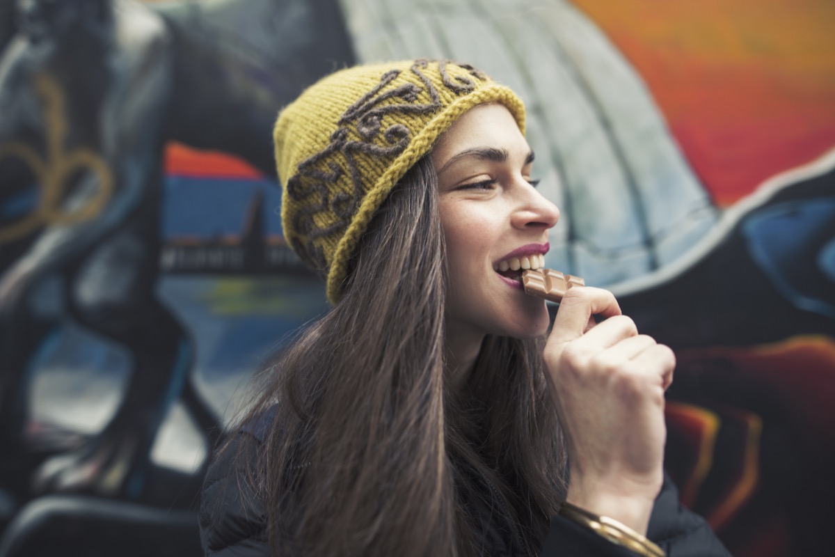 a woman eating a chocolate bar