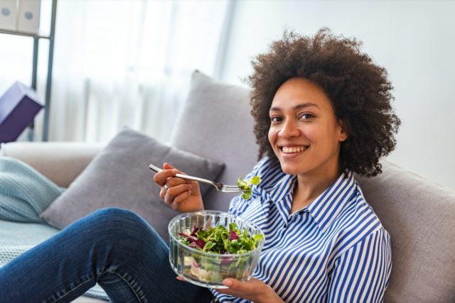 American woman vegan food salad at home