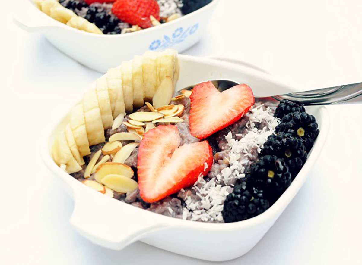 banana blueberry steel cut oatmeal topped with sliced bananas strawberries almonds coconut blackberries