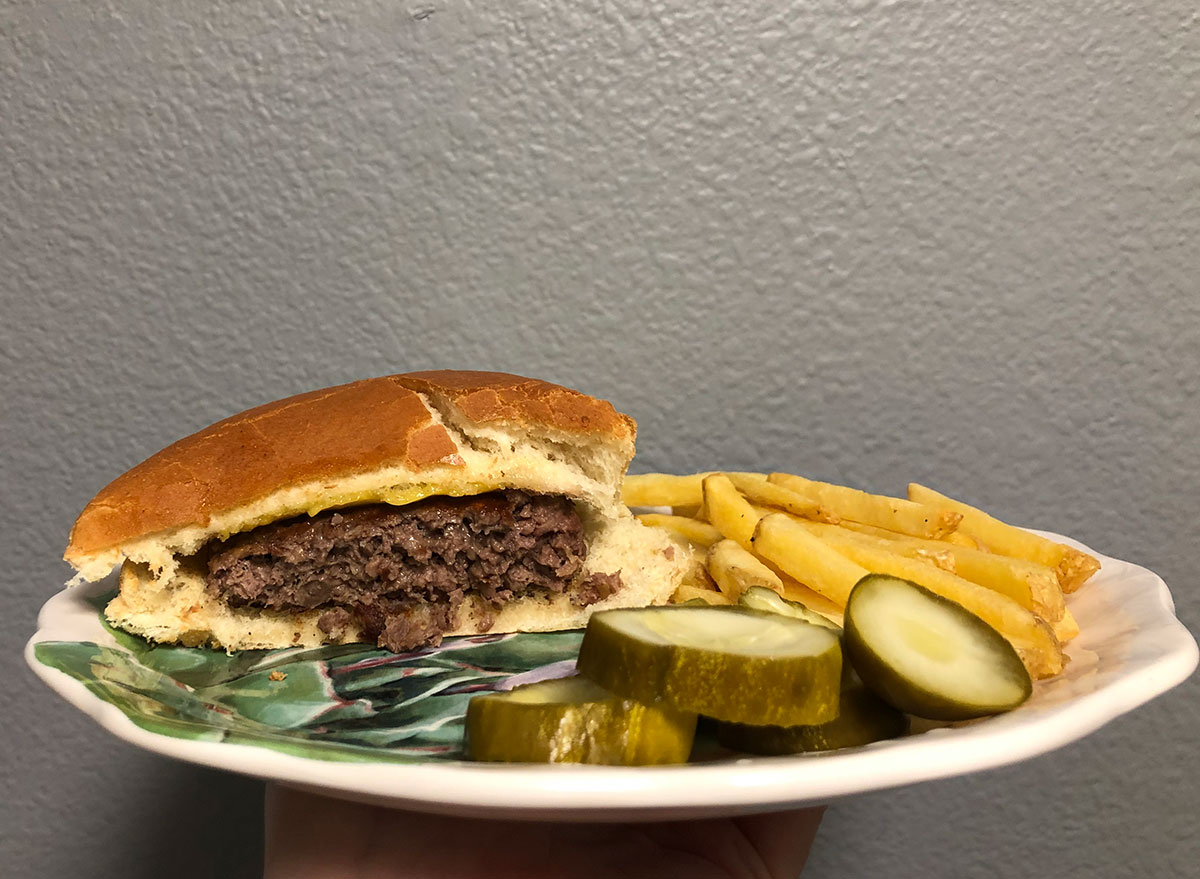 cooked impossible burger with pickles and fries