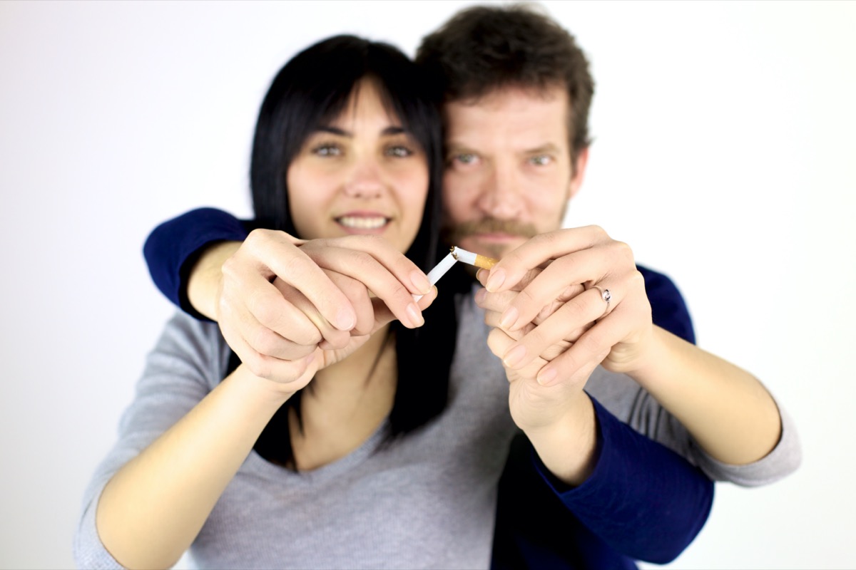 Man and woman breaking cigarette quitting smoke