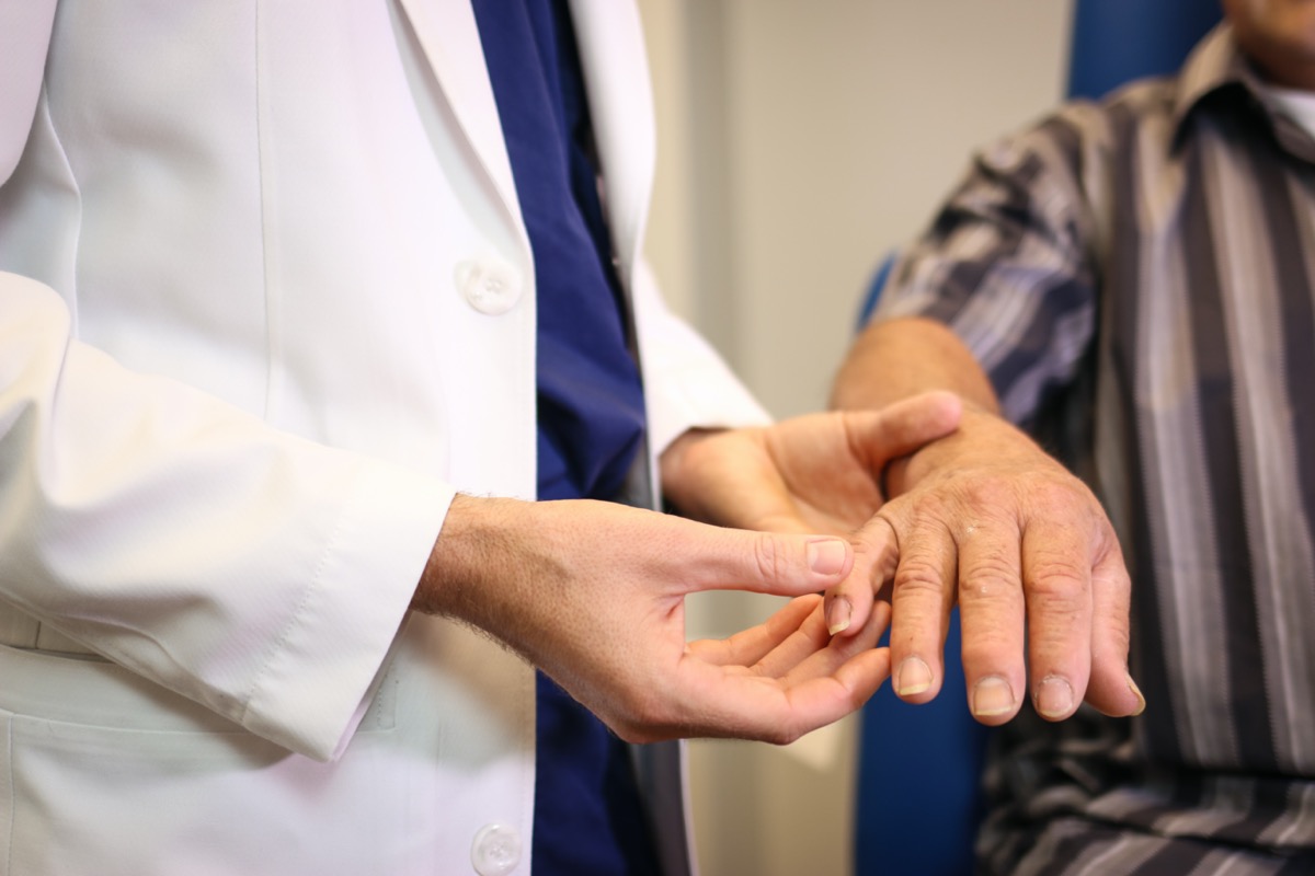 Plastic surgeon examining a hand