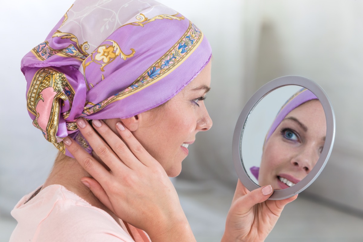 Beautiful woman with a headscarf looking on mirror