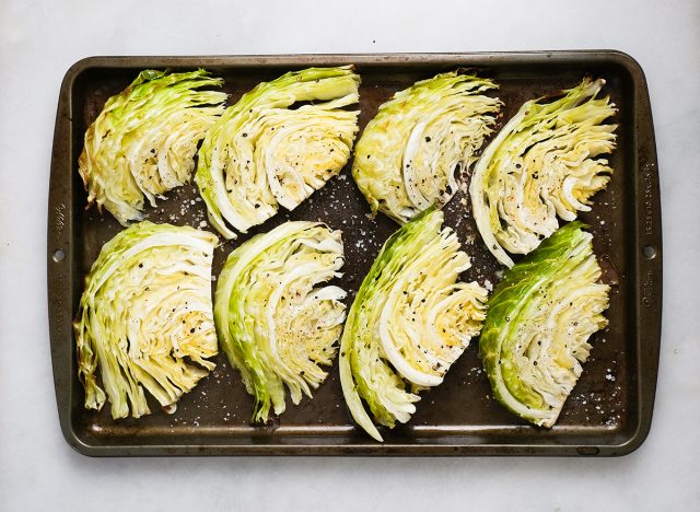 cooked cabbage wedges on a baking sheet