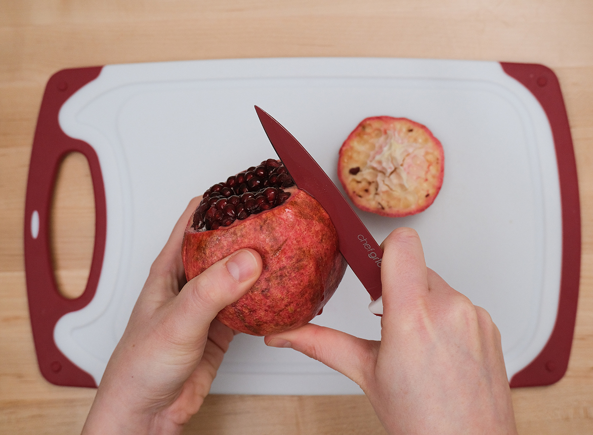 cutting the side of a pomegranate