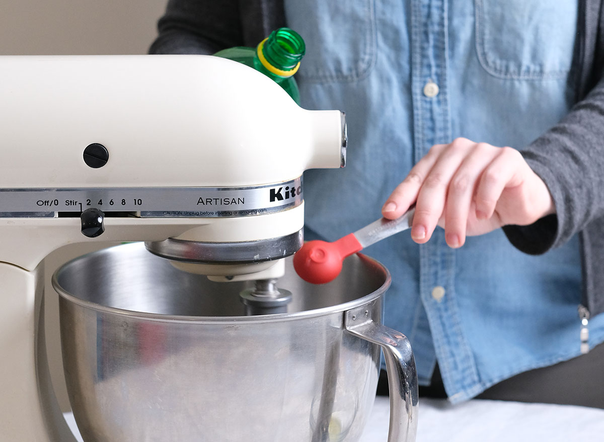 adding lemon juice to a stand mixer