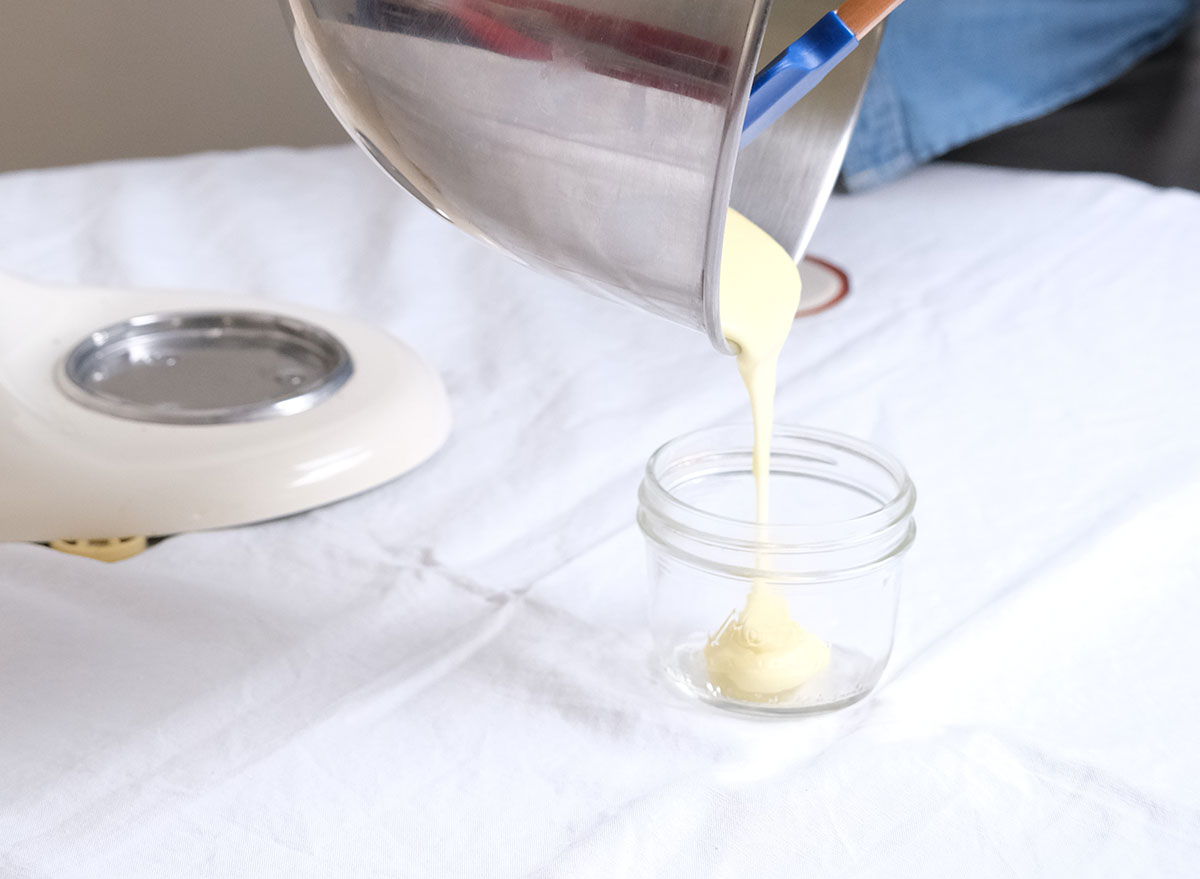 pouring homemade mayonnaise into a jar