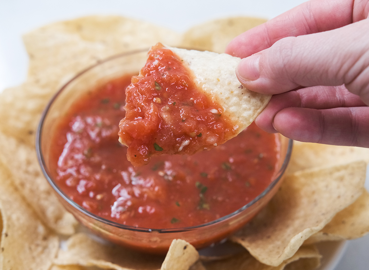 dipping into salsa with a tortilla chip