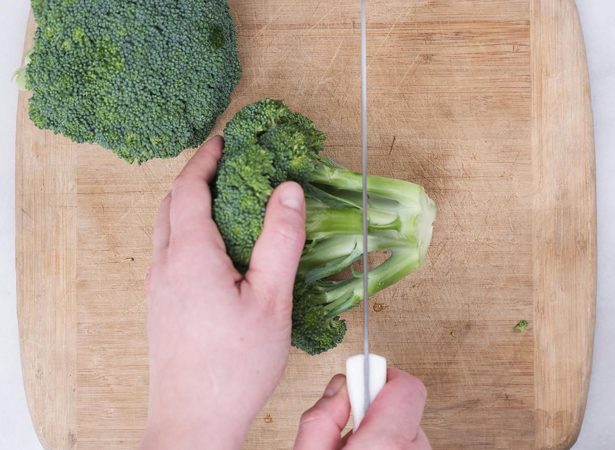 cutting the bottom of a broccoli crown