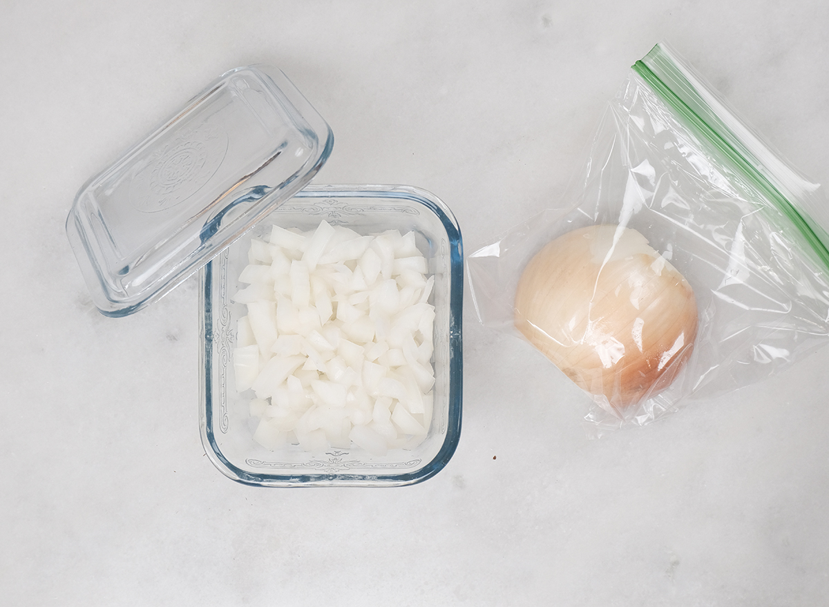 chopped onions in a container and half an onion in a bag