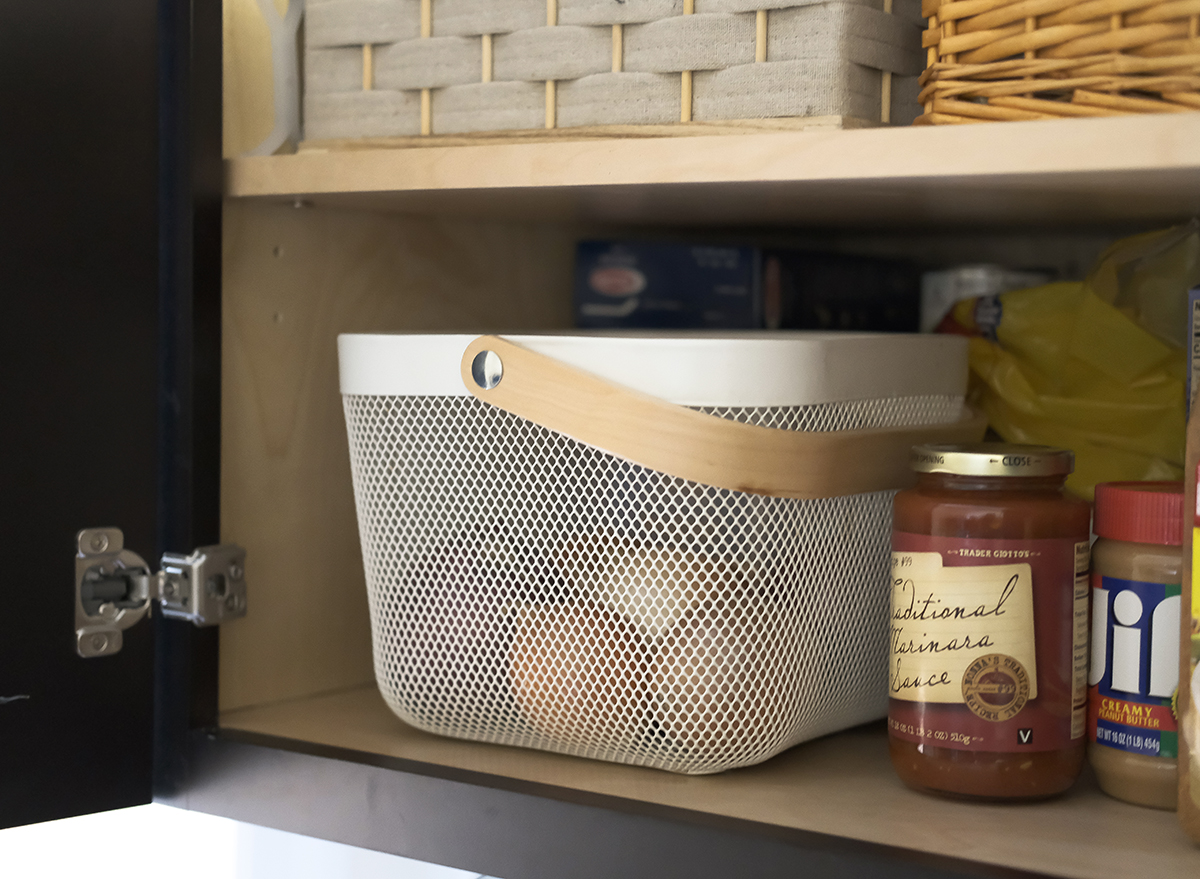 onions in a basket stored in a cabinet