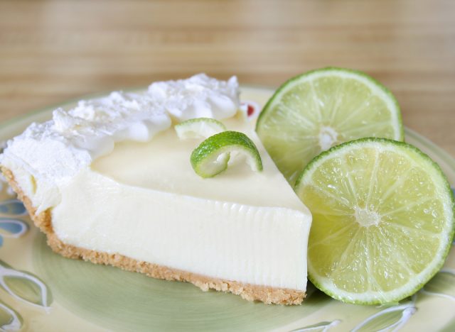 slice of key lime pie with fresh lime slices