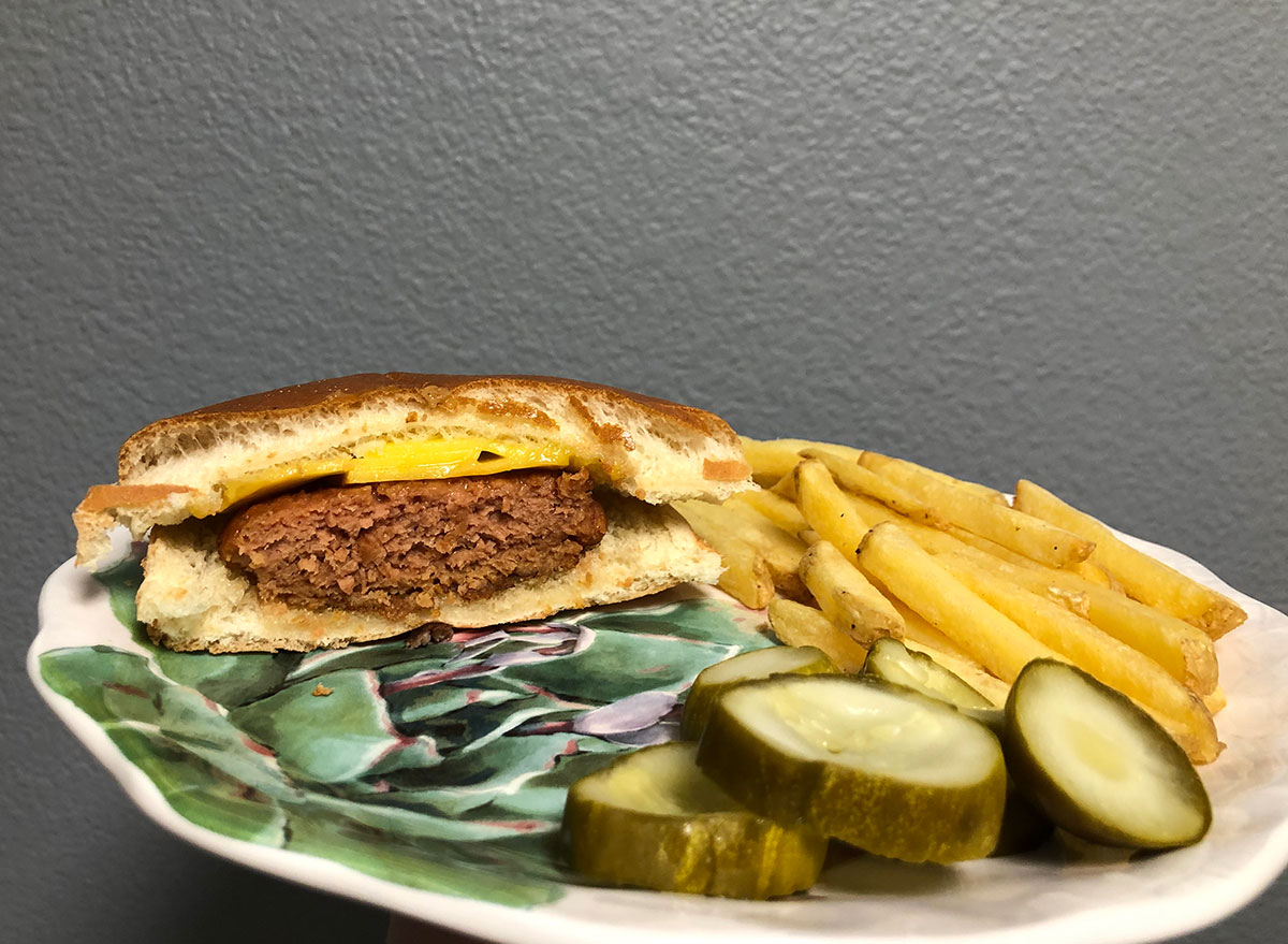 cooked lightlife burger with fries and pickles