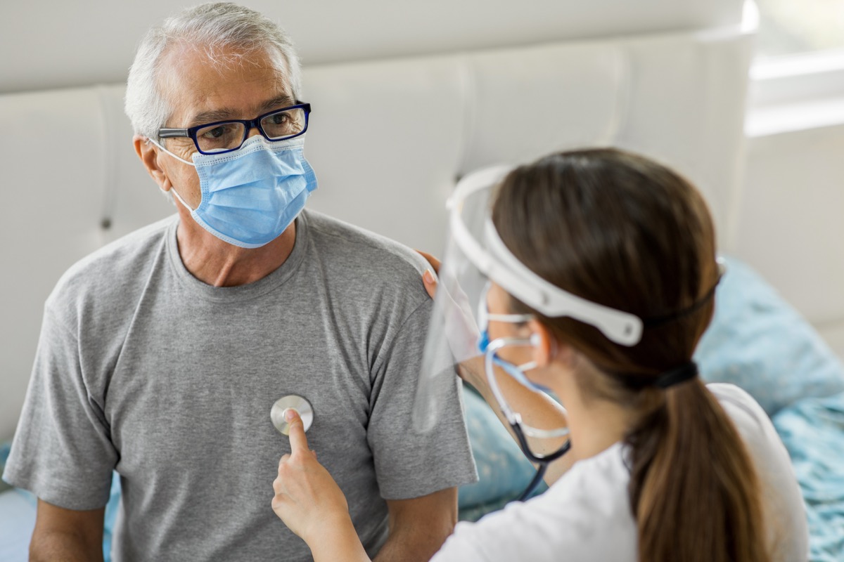 Health visitor and a senior man during home visit